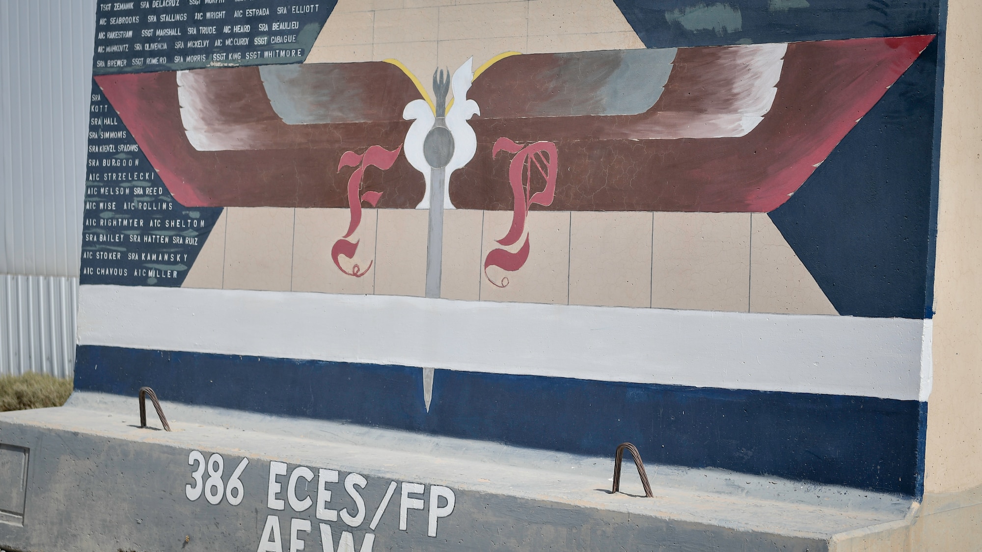 A force protection mural is placed by the force protection flight area at Ali Al Salem Air Base, Kuwait, Sept. 4, 2019. The flight is assigned to the 386th Expeditionary Civil Engineer Squadron and it's manned by 132 Airmen from over 91 different AFSCs from around the Air Force and provide a security buffer between other country nationals such as contractors, their employees and the general base population. In addition to performing as security forces augmentees in case of increase of the threat level to the base. (U.S. Air Force photo by Staff Sgt. Mozer O. Da Cunha)