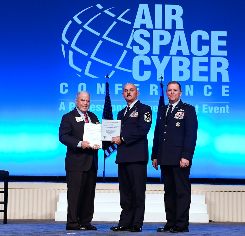 Master Sgt. Peter Thompson and Robert Burton receive the Citizen Airman and Employer of the Year Award during the Air Force Association Air, Space and Cyber Conference in National Harbor, Md., Sept. 16, 2019. (U.S. Air Force photo by Andy Morataya)