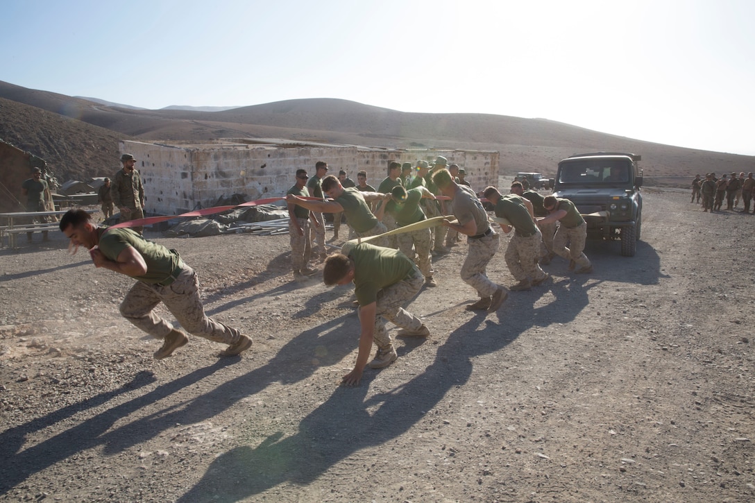 U.S. Marines and Sailors with Special Purpose Marine Air-Ground Task Force-Crisis Response-Africa 19.2, Marine Forces Europe and Africa, pull a vehicle during a field meet in Fuerteventura, Canary Islands, Spain, Sept. 11, 2019. The Marines competed against Spanish soldiers to celebrate the end of their bilateral exercise and increase camaraderie. SPMAGTF-CR-AF is deployed to conduct crisis-response and theater-security operations in Africa and promote regional stability by conducting military-to-military training exercises throughout Europe and Africa. (U.S. Marine Corps photo by Staff Sgt. Mark E Morrow Jr)