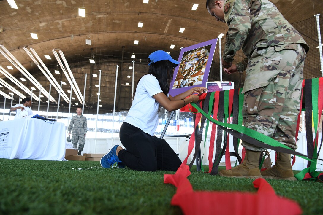 Airmen set up at a table at a Diversity Day event at Ellsworth Air Force Base, S.D., Aug. 16, 2019. Ellsworth hosted the event to celebrate all the cultures, heritage and food from different parts of the world and to highlight the diversity on base. (U.S. Air Force photo by Senior Airman Thomas Karol)