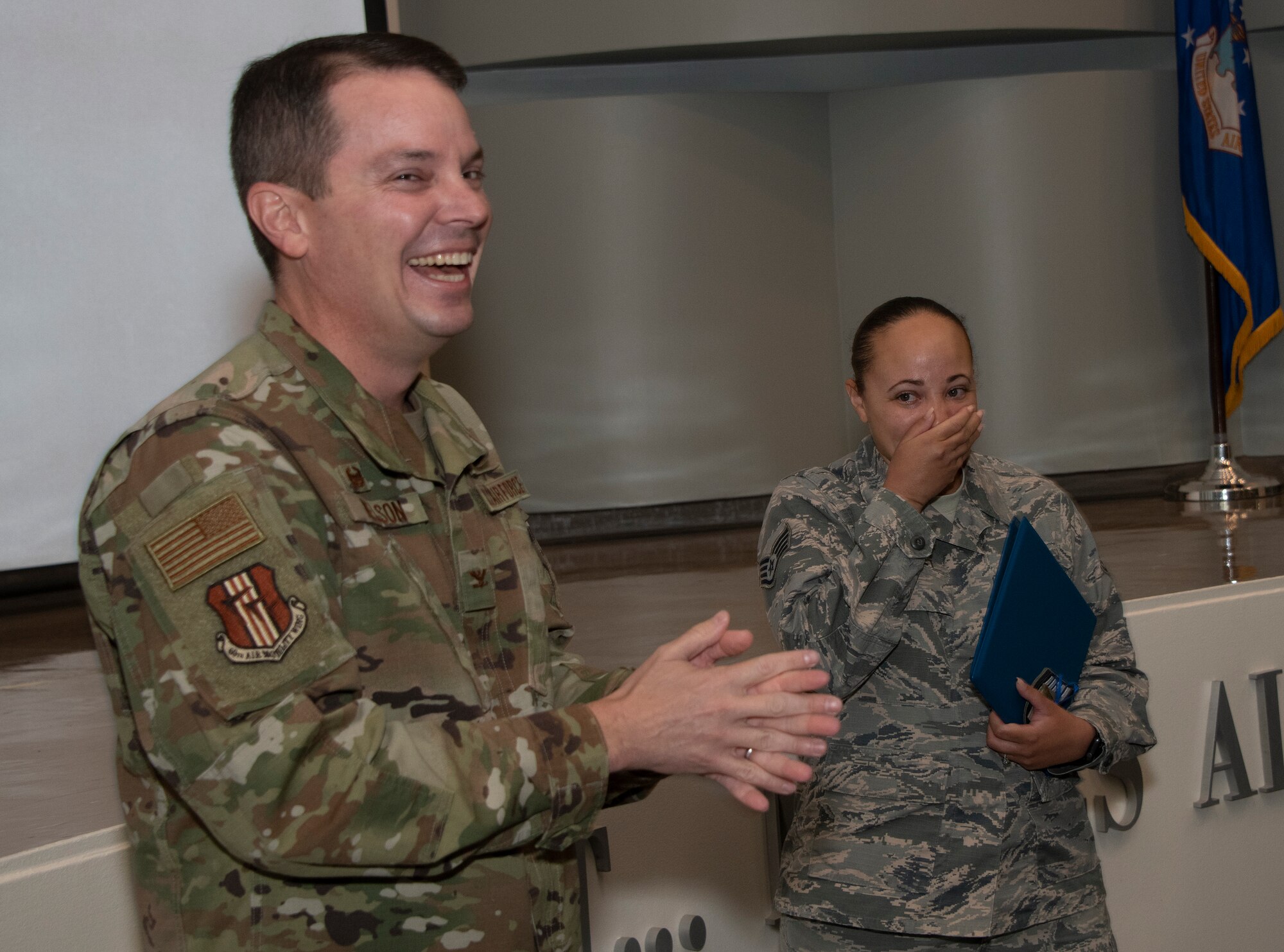U.S. Air Force Col. Jeffrey Nelson, left, 60th Air Mobility Wing commander, presents Staff Sgt. Denise McHaney, 60th Aerospace Medicine Squadron public health supervisor, with her Stripes for Exceptional Performers certificate for technical sergeant Sept. 13, 2019, at David Grant USAF Medical Center, Travis Air Force Base, California. The STEP promotion program offers commanders a limited opportunity to immediately promote enlisted members to staff sergeant or technical sergeant. (U.S. Air Force photo by Heide Couch)