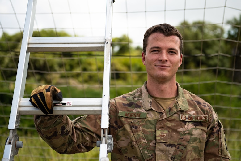 U.S. Air Force Airman 1st Class Jack Murray, 475th Expeditionary Air Base Squadron firefighter, poses for a photo at Camp Simba, Kenya, Aug. 29, 2019. Murray, originally from Tampa Bay, Florida, is responsible for responding to fire emergencies, but also helps train Kenya Navy firefighters on base. During his free time, he lifts weights, participates in Judo, and regularly plays table tennis in the Morale, Welfare, and Recreation center. (U.S. Air Force photo by Staff Sgt. Devin Boyer)
