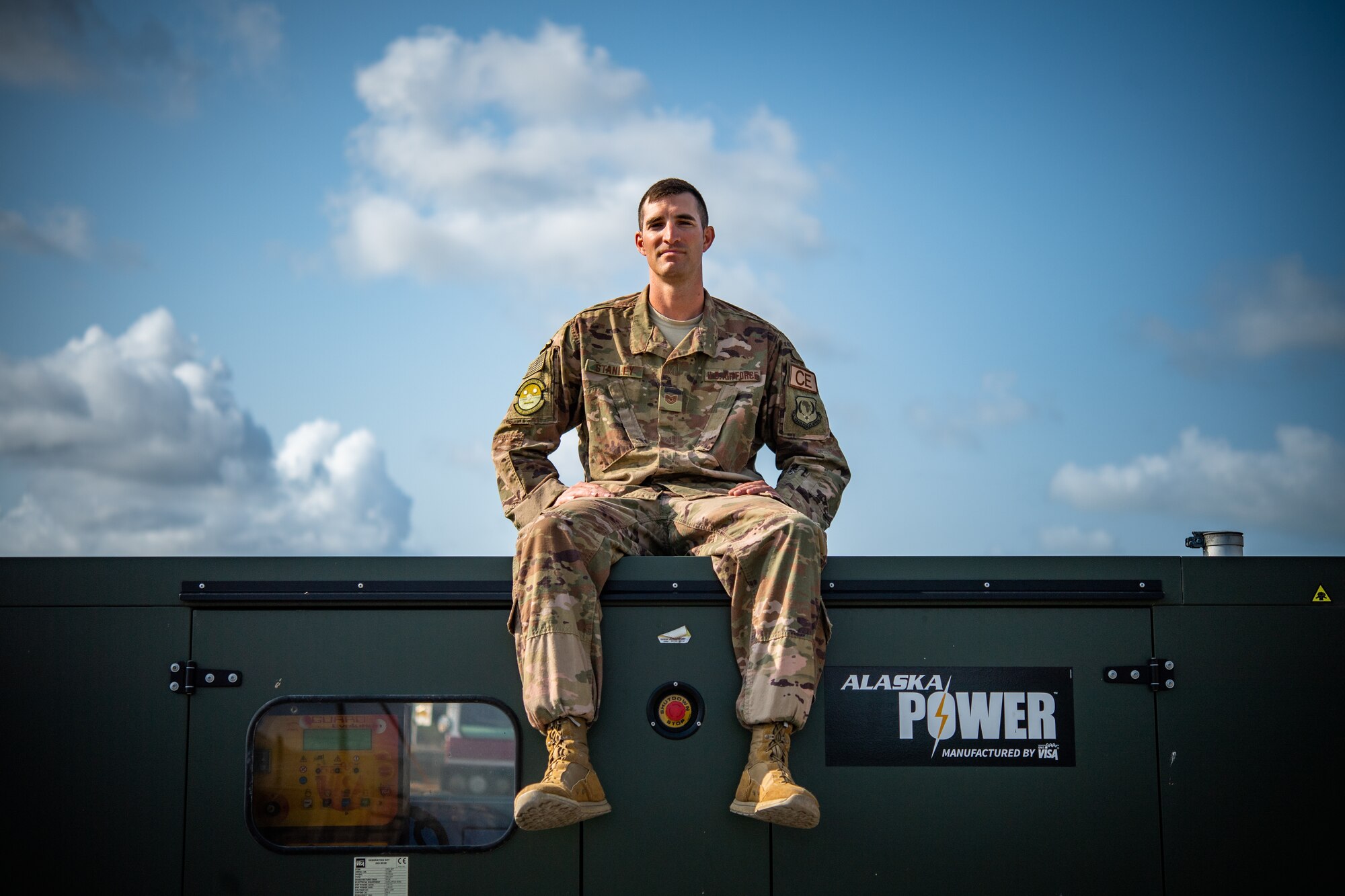 U.S. Air Force Tech. Sgt. Alexander Stanley, 475th Expeditionary Air Base Squadron electrical systems noncommissioned officer in charge, poses for a photo on top of a generator at Camp Simba, Kenya, Sep. 2, 2019. Stanley, originally from Vancouver, Washington, is responsible for quality assurance on electrical construction projects and the maintenance for the 3,000 ft runway lighting system at Camp Simba. At home he enjoys building and working on cars. During his deployment, he enjoys working on construction projects to improve quality of life around the compound. (U.S. Air Force photo by Staff Sgt. Devin Boyer)