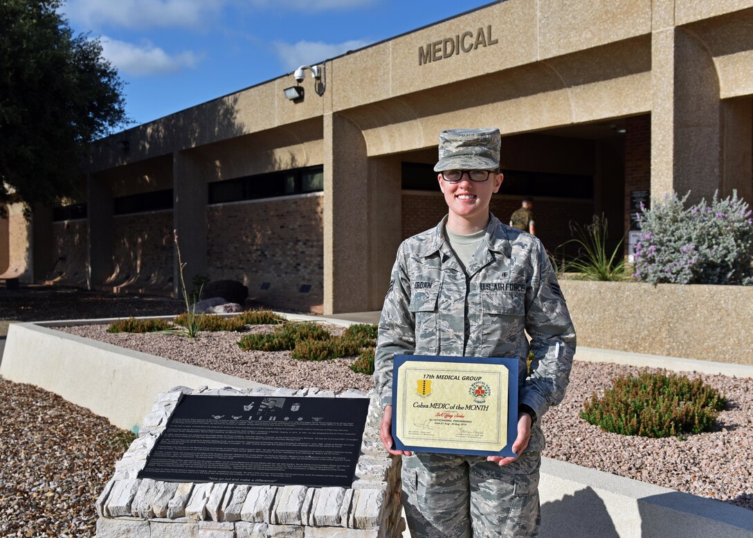U.S. Air Force Senior Airman Tiffany Jordan, 17th Healthcare Operations Squadron medical technician, stands with the Medic of the Month award outside of the Ross Clinic on Goodfellow Air Force Base, Texas, September 9, 2019. Jordan exceeded her leadership’s standards of professionalism and expertise functioning at a flight chief level as a senior Airman. (U.S. Air Force photo by Senior Airman Seraiah Wolf/Released)