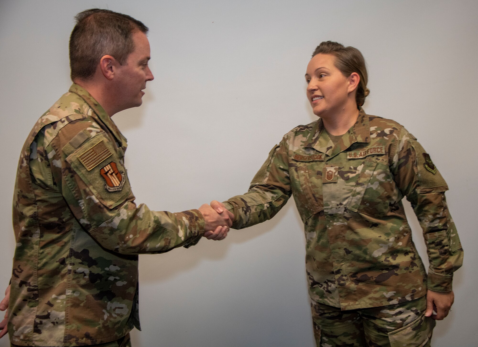 U.S. Air Force Col. Jeffrey Nelson, left, 60th Air Mobility Wing commander, coins Master Sgt. Tracy Roberts, 60th Dental Squadron dental laboratory flight chief, during Leadership Rounds Sept. 13, 2019 at David Grant USAF Medical Center, Travis Air Force Base, California.  The Leadership Rounds program involves wing leadership interacting with Airmen to get a detailed view of each mission performed at Travis AFB.  (U.S. Air Force photo by Heide Couch)