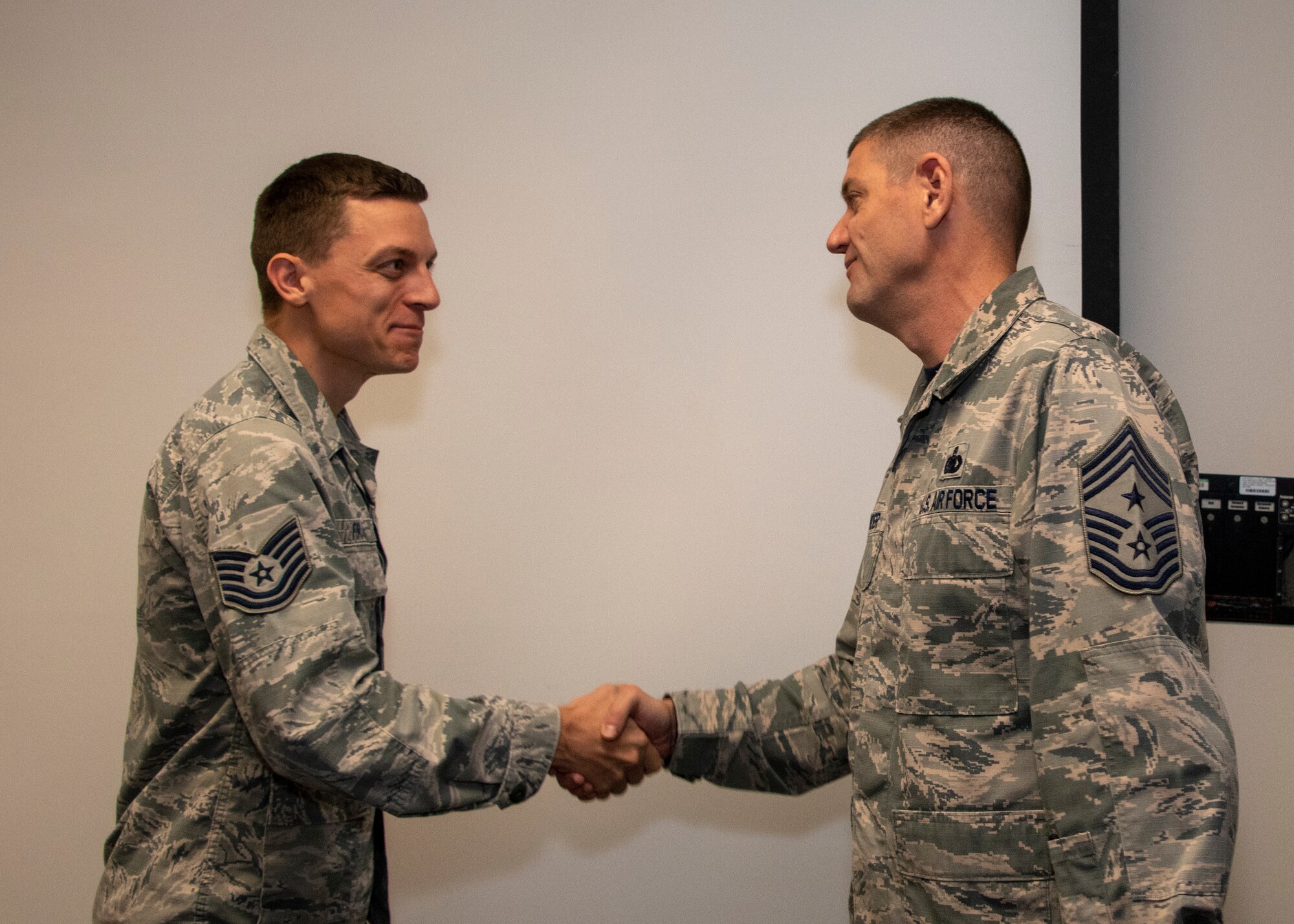 U.S. Air Force Chief Master Sgt. Derek Crowder, right, 60th Air Mobility Wing command chief, coins Tech. Sgt.  John Foran, 60th Dental Squadron support flight chief during Leadership Rounds Sept. 13, 2019 at David Grant USAF Medical Center, Travis Air Force Base, California.  The Leadership Rounds program involves wing leadership interacting with Airmen to get a detailed view of each mission performed at Travis AFB.  (U.S. Air Force photo by Heide Couch)