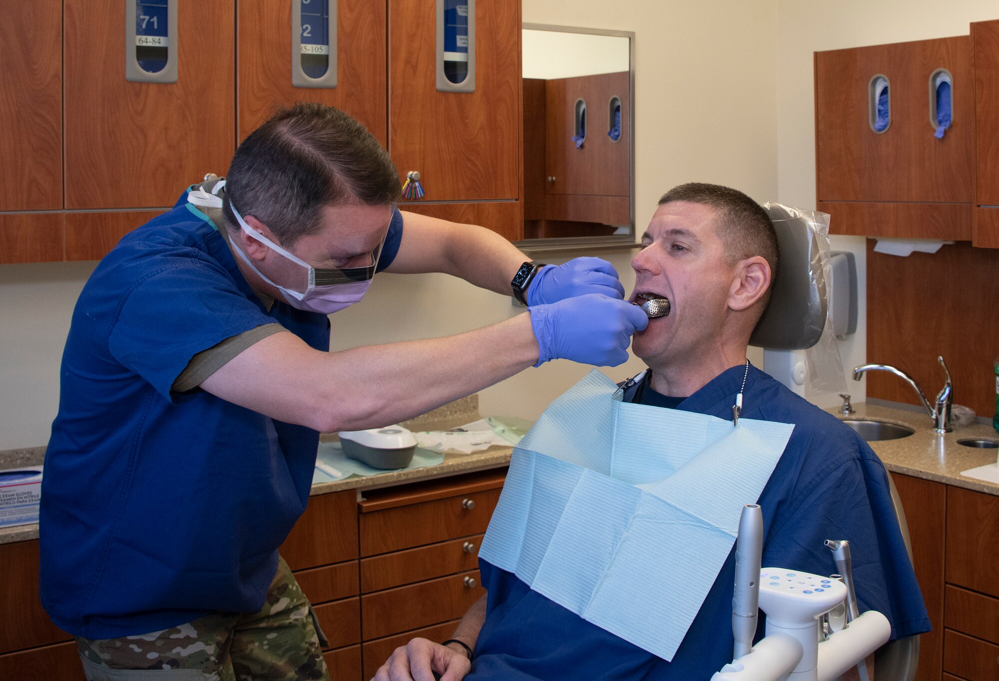 U.S. Air Force Col. Jeffrey Nelson, left, 60th Air Mobility Wing commander, checks the fit of a dental impression tray on Chief Master Sgt. Derek Crowder, 60th AMW command chief as part of Leadership Rounds Sept. 13, 2019, at the 60th Dental Squadron, David Grant USAF Medical Center, Travis Air Force Base, California. The Leadership Rounds program involves wing leadership interacting with Airmen to get a detailed view of each mission performed at Travis AFB. (U.S. Air Force photo by Heide Couch
