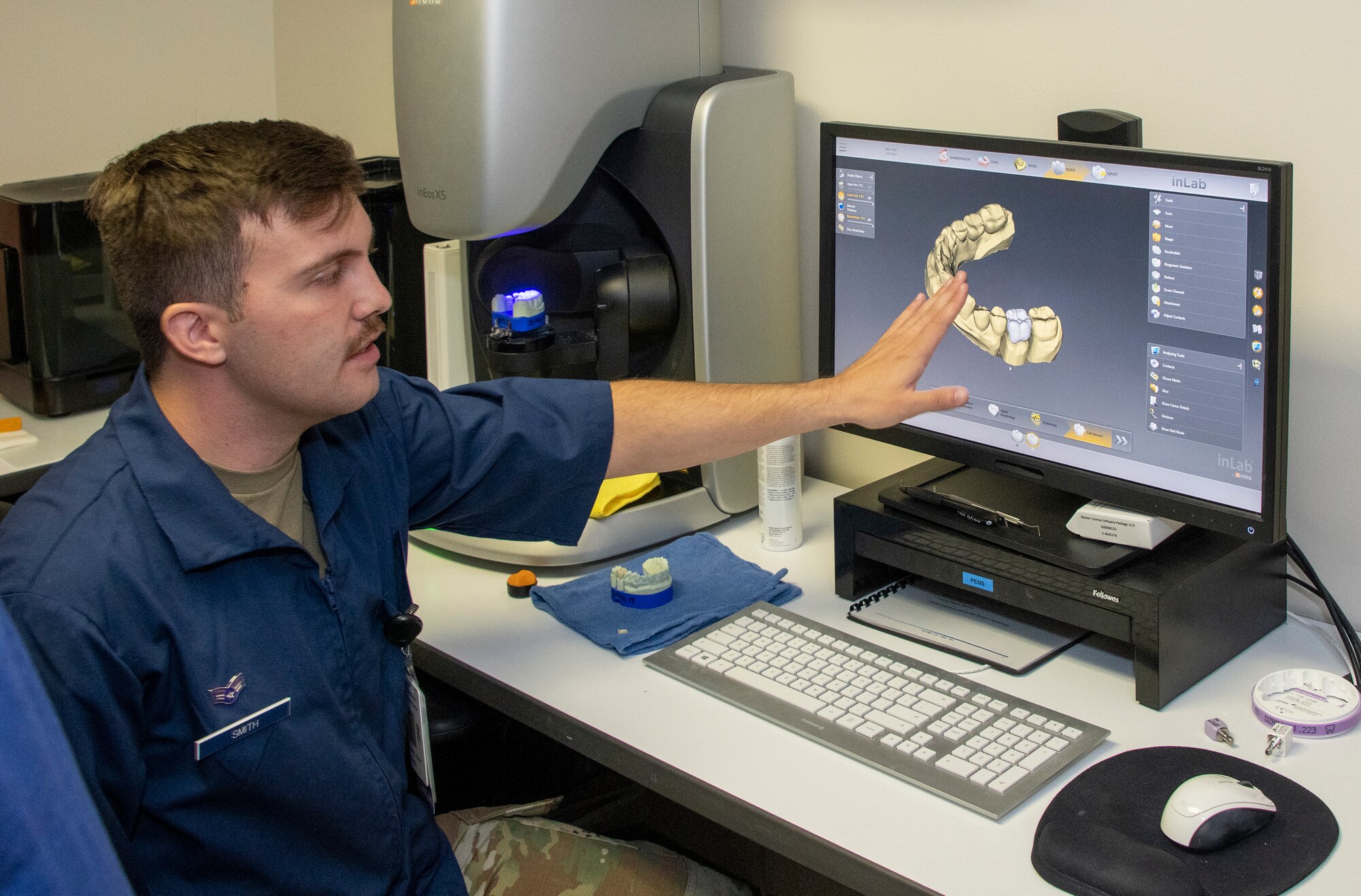 U.S. Air Force Senior Airman Hunter Smith, 60th Dental Squadron dental laboratory technician, manipulates a 3D computer image of a dental impression to separate a single tooth to fabricate a crown for a molar Sept. 13, 2019 at David Grant USAF Medical Center, Travis Air Force Base, California. The dental clinic offers comprehensive dental services for active duty service members, including oral and maxillofacial surgical services. (U.S. Air Force photo by Heide Couch)