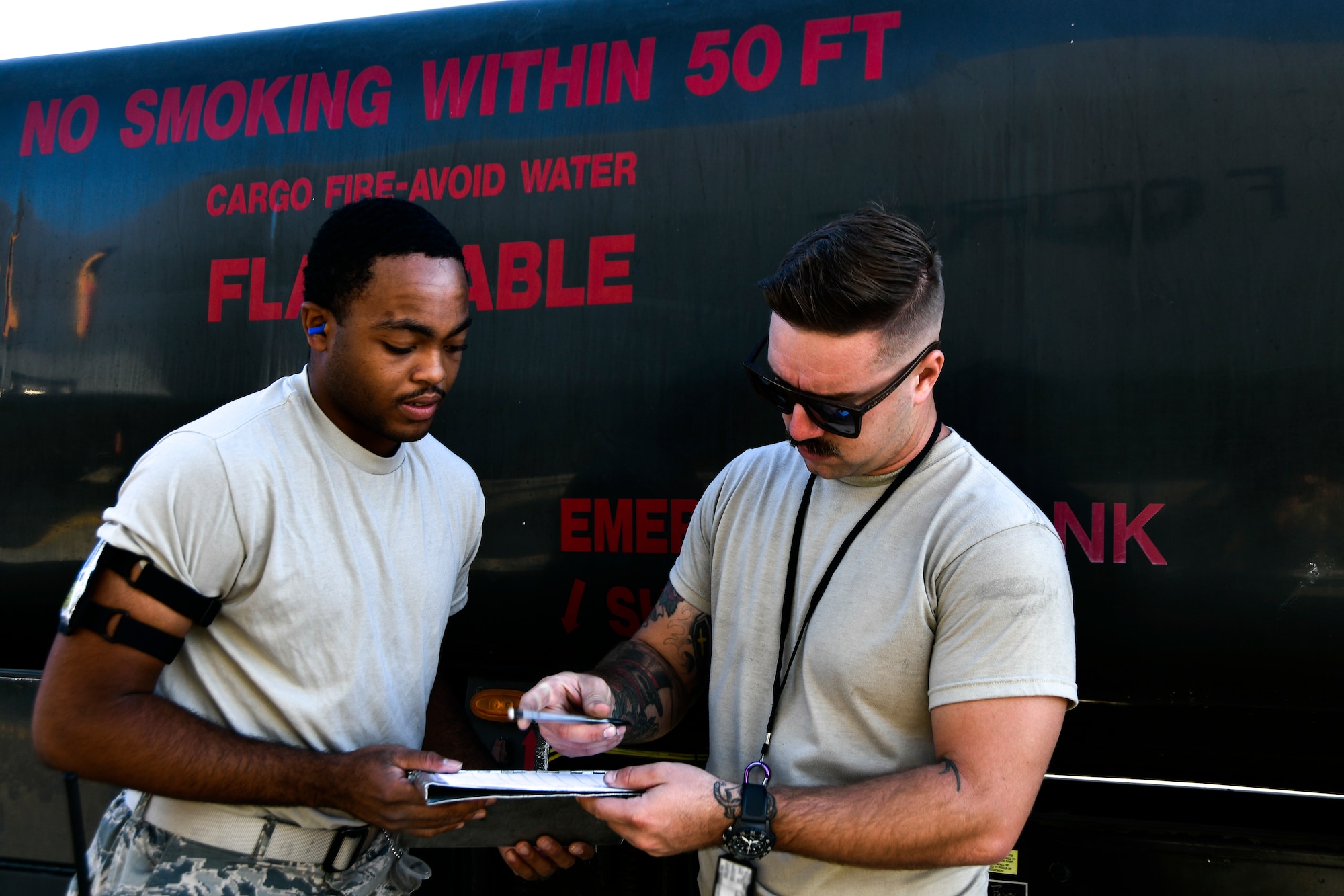 Airman 1st Class Tyrese Kirk, 9th Logistics Readiness Squadron Petroleum, Oil and Lubricants flight fuels distribution system operator, reads off his fuel plan to Staff Sgt. Brandon Buhler, 940th Aircraft Maintenance Squadron crew chief, during a refueling exercise September 6, 2019 at Beale Air Force Base, California. (U.S. Air Force photo by Tech. Sgt. Alexandre Montes)