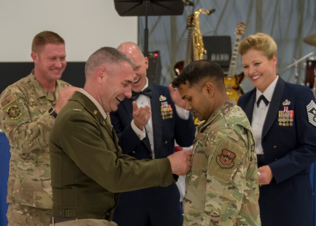 Col. Joseph Campo, 49th Wing commander, pins on rank for newly promoted Tech Sgt. Denzel Ramdhanie, 49th Component Maintenance Squadron avionics back shop production non-commissioned officer in charge at the Air Force Ball, Sept. 14, 2019, on Holloman Air Force Base, N.M. Ramdhanie promoted from staff sergeant to technical sergeant through the Stripes for Exceptional Performers program. (U.S. Air Force photo by Airman 1st Class Kindra Stewart)
