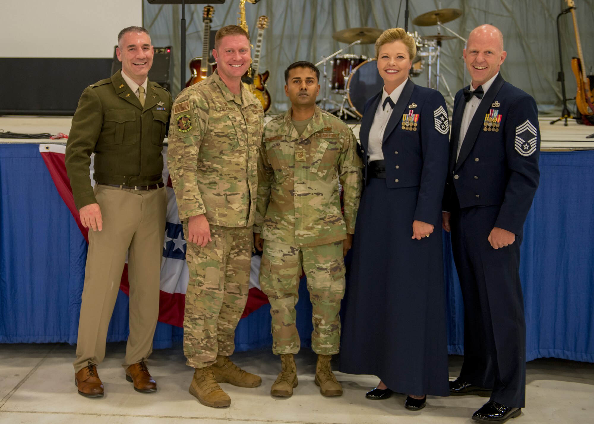 Newly promoted Tech Sgt. Denzel Ramdhanie, 49th Component Maintenance Squadron avionics back shop production non-commissioned officer in charge, poses for a photo with base leadership at the Air Force Ball, Sept. 14, 2019, on Holloman Air Force Base, N.M. Ramdhanie promoted from staff sergeant to technical sergeant through the Stripes for Exceptional Performers program. (U.S. Air Force photo by Airman 1st Class Kindra Stewart)