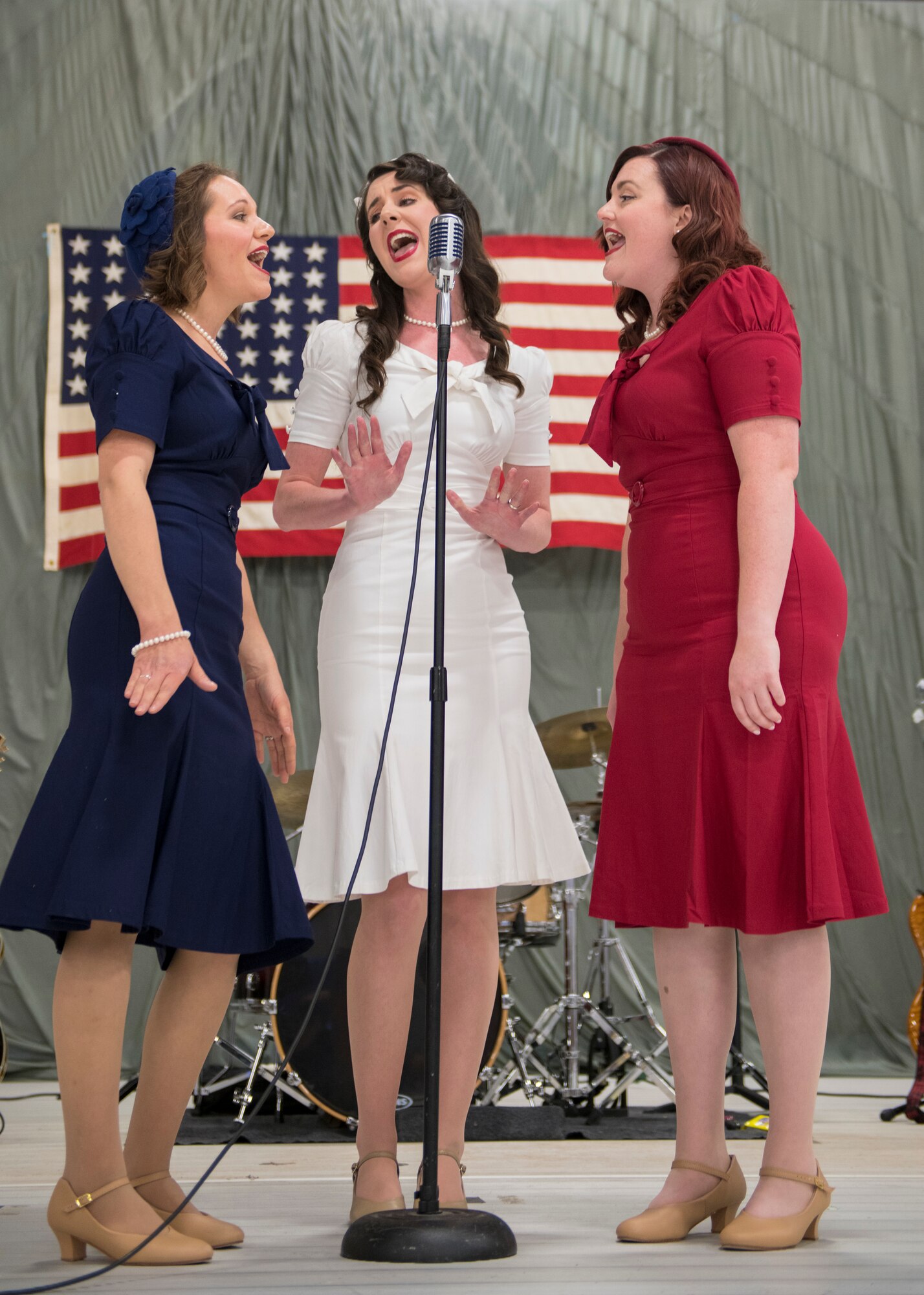 Chloe Hagener, Hilary Marshall and Katie Babbitt (left to right), singers from the local community theater, sing at the Air Force Ball, Sept. 14, 2019, on Holloman Air Force Base, N.M. Every September, the Air Force Ball is celebrated by bases all over the world to commemorate the day the United States Air Force was established, Sept. 18, 1947. (U.S. Air Force photo by Airman 1st Class Kindra Stewart)