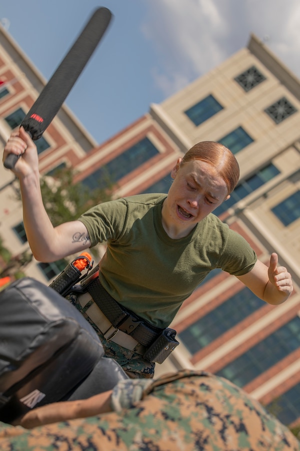 U.S. Marine Corps Lance Cpl. Hope Sayre, an administrative clerk with Headquarters Battalion, strikes a training pad during the Security Augmentation Force course at Marine Corps Support Facility New Orleans, Sept. 13, 2019. SAF training is designed to provide the facility with qualified and properly trained personnel ready to support the military provost marshal’s office. SAF Marines are required to participate in defensive tactics training, a gate procedures class, vehicle search training and qualify for level one contamination with oleoresin capsicum spray. (U.S. Marine Corps photo by Pfc. Leslie Alcaraz)