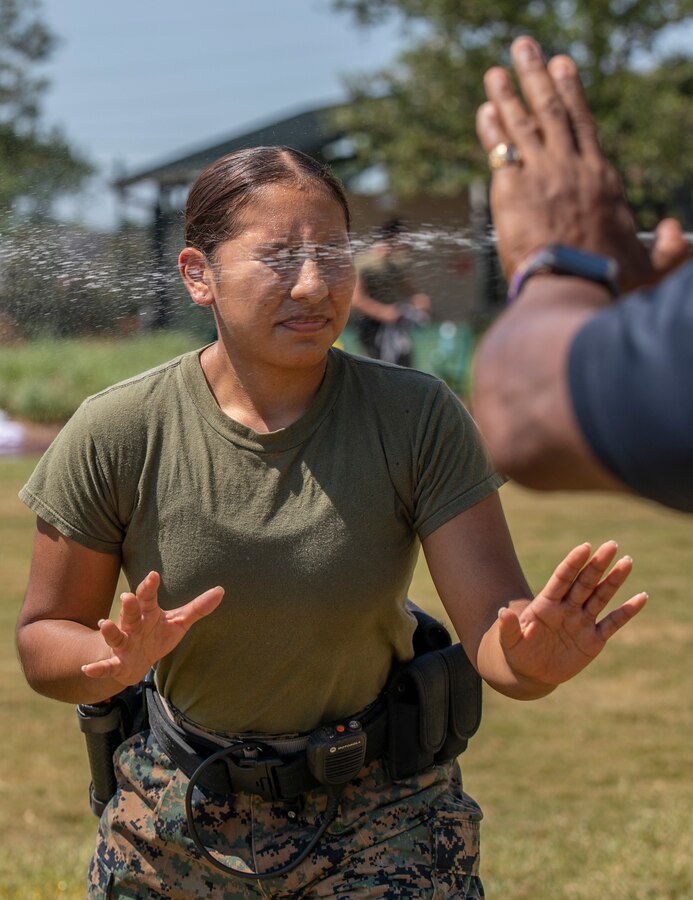 U.S. Marine Corps Lance Cpl. Ashley Barreno, a combat videographer with Communication Strategy and Operations, Headquarters Battalion, gets sprayed with oleoresin capsicum during the Security Augmentation Force course at Marine Corps Support Facility New Orleans, Sept. 13, 2019. OC spray is a nonlethal weapon Marines may use while on SAF duty. SAF training is designed to provide the facility with qualified and properly trained personnel ready to support the military provost marshal’s office. SAF Marines are required to participate in defensive tactics training, a gate procedures class, vehicle search training and qualify for level one contamination with oleoresin capsicum spray. (U.S. Marine Corps photo by Pfc. Leslie Alcaraz)