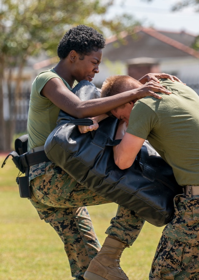 U.S. Marine Corps Lance Cpl. Asha Hester, an administrative clerk with G-1, 4th Marine Logistics Group, strikes a training pad during a Security Augmentation Force course at Marine Corps Support Facility New Orleans, Sept. 13, 2019. SAF training is designed to provide the facility with qualified and properly trained personnel ready to support the military provost marshal’s office. SAF Marines are required to participate in defensive tactics training, a gate procedures class, vehicle search training and qualify for level one contamination with oleoresin capsicum spray. (U.S. Marine Corps photo by Pfc. Leslie Alcaraz)