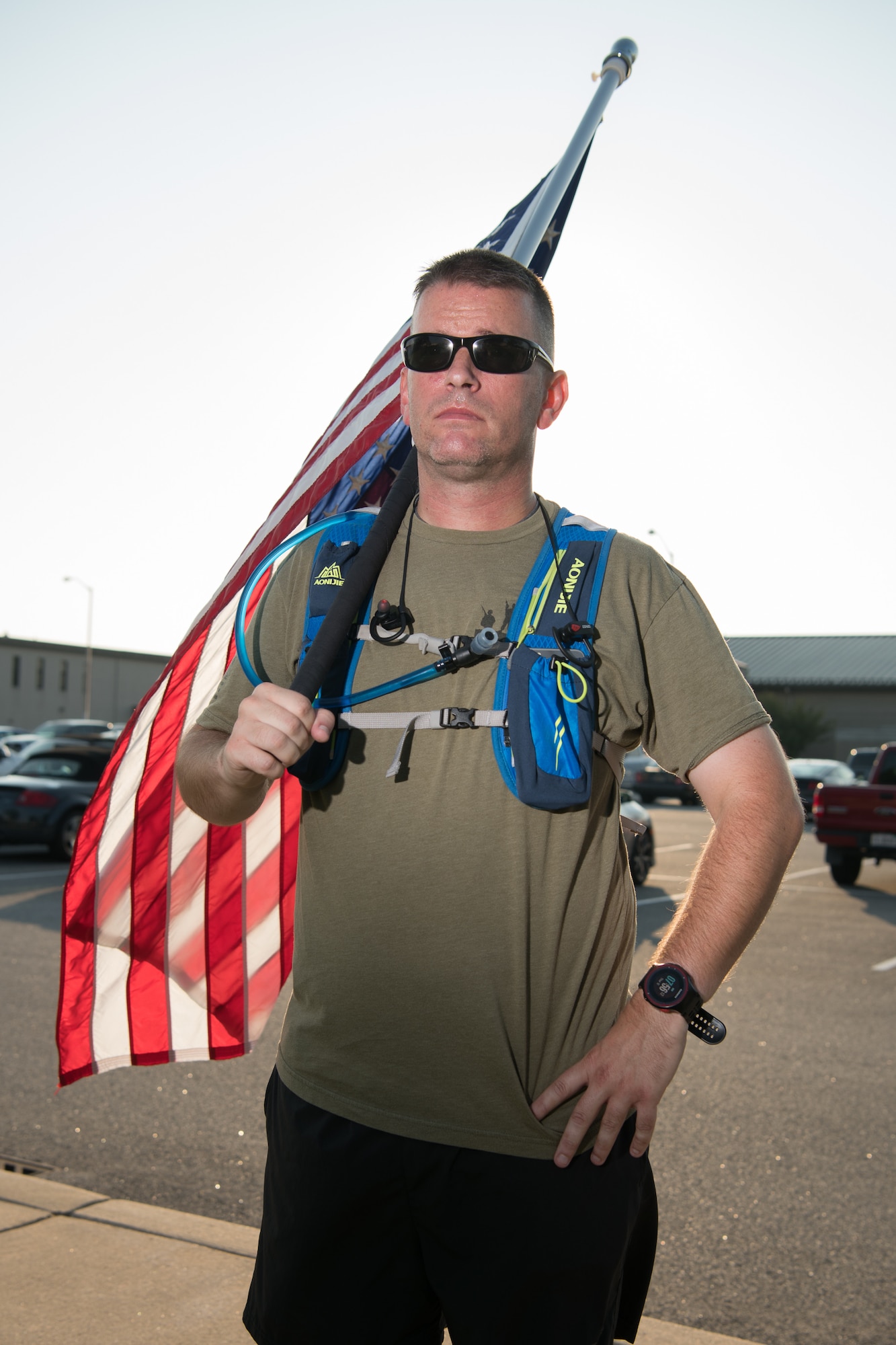 Master Sgt. Trevor Derr, 736th Aircraft Maintenance Squadron C-17 production superintendent, holds an American flag over his shoulder Sept. 12, 2019, at Dover Air Force Base, Del. Derr carries the flag whenever he runs to honor the memory of a friend he lost to suicide, and raise awareness of post-traumatic stress disorder. (U.S. Air Force Photo by Mauricio Campino)