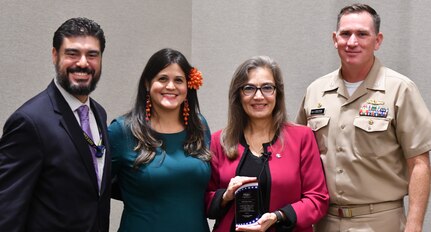 IMAGE: KING GEORGE, Va. (Sept. 13, 2019) – Sandra Alba Cauffman – acting division director of the Earth Science Division at the National Aeronautics and Space Administration (NASA) Science Mission Directorate – holds a plaque she received from Eunice Mercado, Naval Surface Warfare Center Dahlgren Division (NSWCDD) Hispanic Employment Program manager, in appreciation of her keynote speech at the NSWCDD-sponsored Hispanic Heritage Month Observance. “Follow your dreams and do something you’re really passionate about,” said Cauffman, a native of Costa Rica, who was inspired to work for NASA while watching the Apollo 11 moon landing as a seven year old. Standing left to right are Luis Rodriguez, NSWCDD Hispanic Employment Program champion, Mercado, Cauffman, and Capt. Casey Plew, NSWCDD commanding officer.