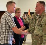 Col. Scott Meyers, director of human resources, Michigan National Guard Joint Force Headquarters, Lansing, Mich., presents the Michigan National Guard Lifesaving medal to the family of Staff Sgt. Justin Skaggs during a ceremony at Camp Grayling Joint Maneuver Training Center, Mich., Sept. 14, 2019. Skaggs, a Soldier with the 1225th Support Battalion, Detroit, Mich., died after a motorcycle accident May 23. His decision to be an organ donor saved several lives.