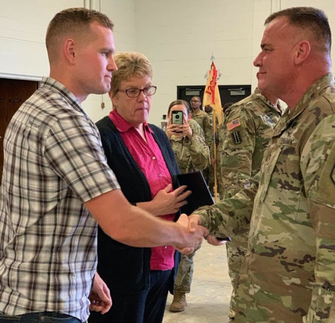 Col. Scott Meyers, director of human resources, Michigan National Guard Joint Force Headquarters, Lansing, Mich., presents the Michigan National Guard Lifesaving medal to the family of Staff Sgt. Justin Skaggs during a ceremony at Camp Grayling Joint Maneuver Training Center, Mich., Sept. 14, 2019. Skaggs, a Soldier with the 1225th Support Battalion, Detroit, Mich., died after a motorcycle accident May 23. His decision to be an organ donor saved several lives.