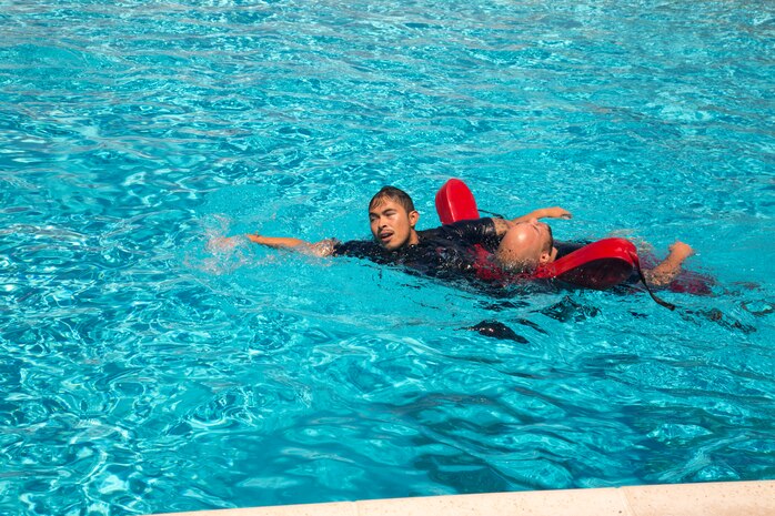 Francisco Cadillo, primary lifeguard, Oasis Pool, has just recovered passive and unresponsive drowning “victim” Axel Rivera, lifeguard supervisor, from the bottom of the pool during an Emergency Action Plan training exercise August 27. Elements of the Marine Corps Fire Department also participated in this first ever special training exercise to ensure the Oasis Pool and fire department personnel remain trained and ready to go at a moment’s notice to keep the MCLB Barstow aquatics center a safe place for pool patrons.