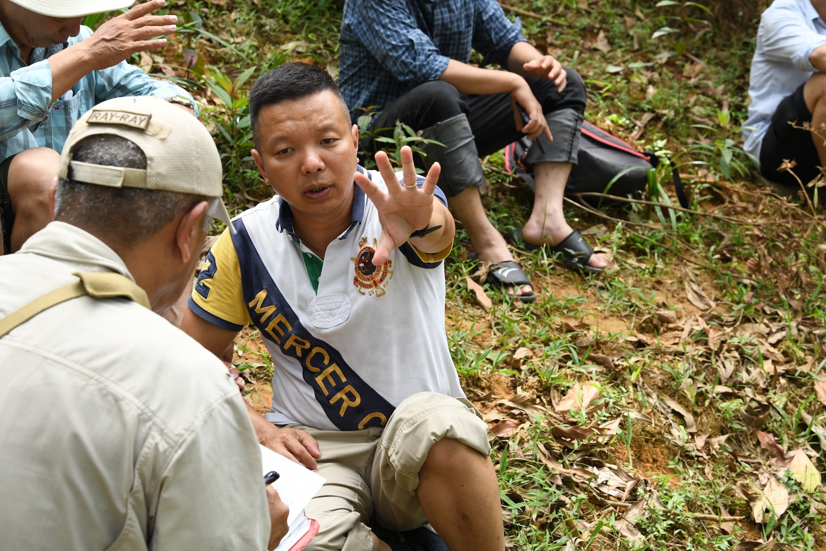 U.S. Army Sgt. 1st Class Kelvin Ngo, a linguist with the Defense POW/MIA Accounting Agency (DPAA) translates a witness account to Ray Kern, a DPAA analyst, during an investigation in Quang Nam province, Socialist Republic of Vietnam, June 17, 2019. DPAA was in the region conducting investigations in search of servicemembers who went missing during the Vietnam War. DPAA's mission is to provide the fullest possible accounting for our missing personnel to their families and the nation. (U.S. Navy photo by Mass Communication Specialist 1st Class Amara Timberlake)