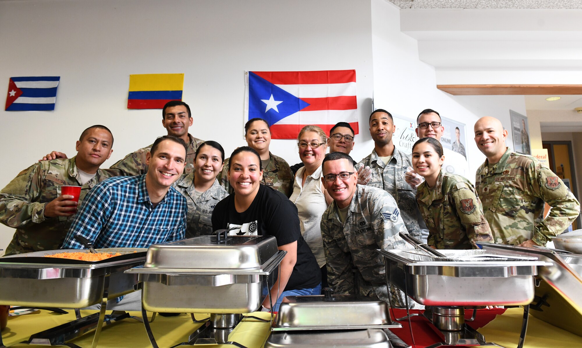 Members of the Ellsworth Latin American Community (ELAC) pose proudly behind dishes they cooked for the ‘Taste of Latin America’ food tasting event, held at the Base Exchange food court, on Ellsworth Air Force Base, S.D., Sept. 16, 2019. The ELAC was created to recognize the diverse cultures and contributions of Latin and Hispanic American people throughout the Ellsworth AFB community. (U.S. Air Force photo by Airman 1st Class Christina Bennett)