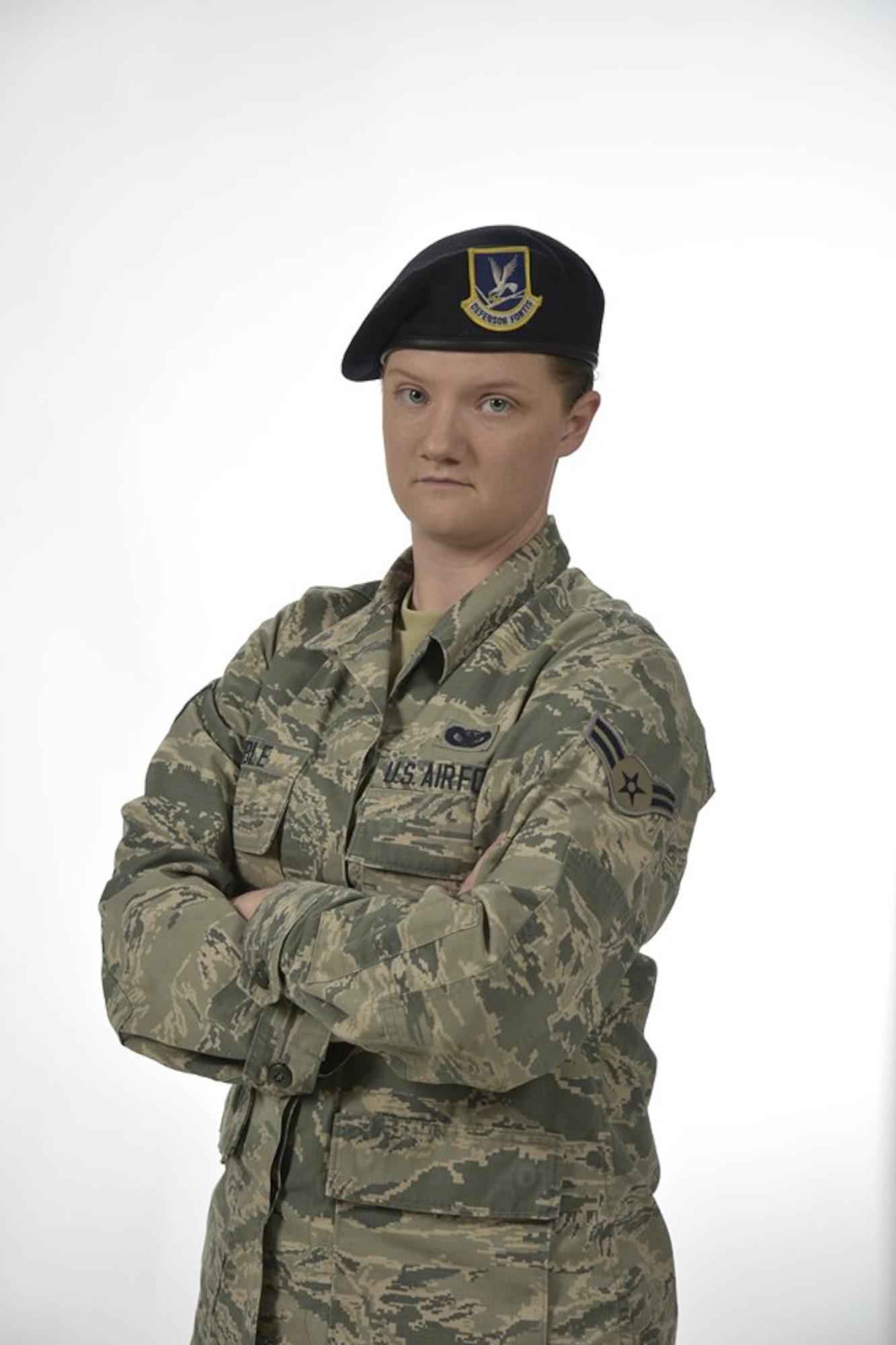 Airman First Class Kaitlyn Coble, 21st Security Forces Squadron entry controller, poses for a photo for the Year of the Defender campaign at Peterson Air Force Base, Colorado. Coble works as an entry controller for Cheyenne Mountain Air Force Station in Colorado. (U.S. Air Force illustration by Airman Alexis Christian)