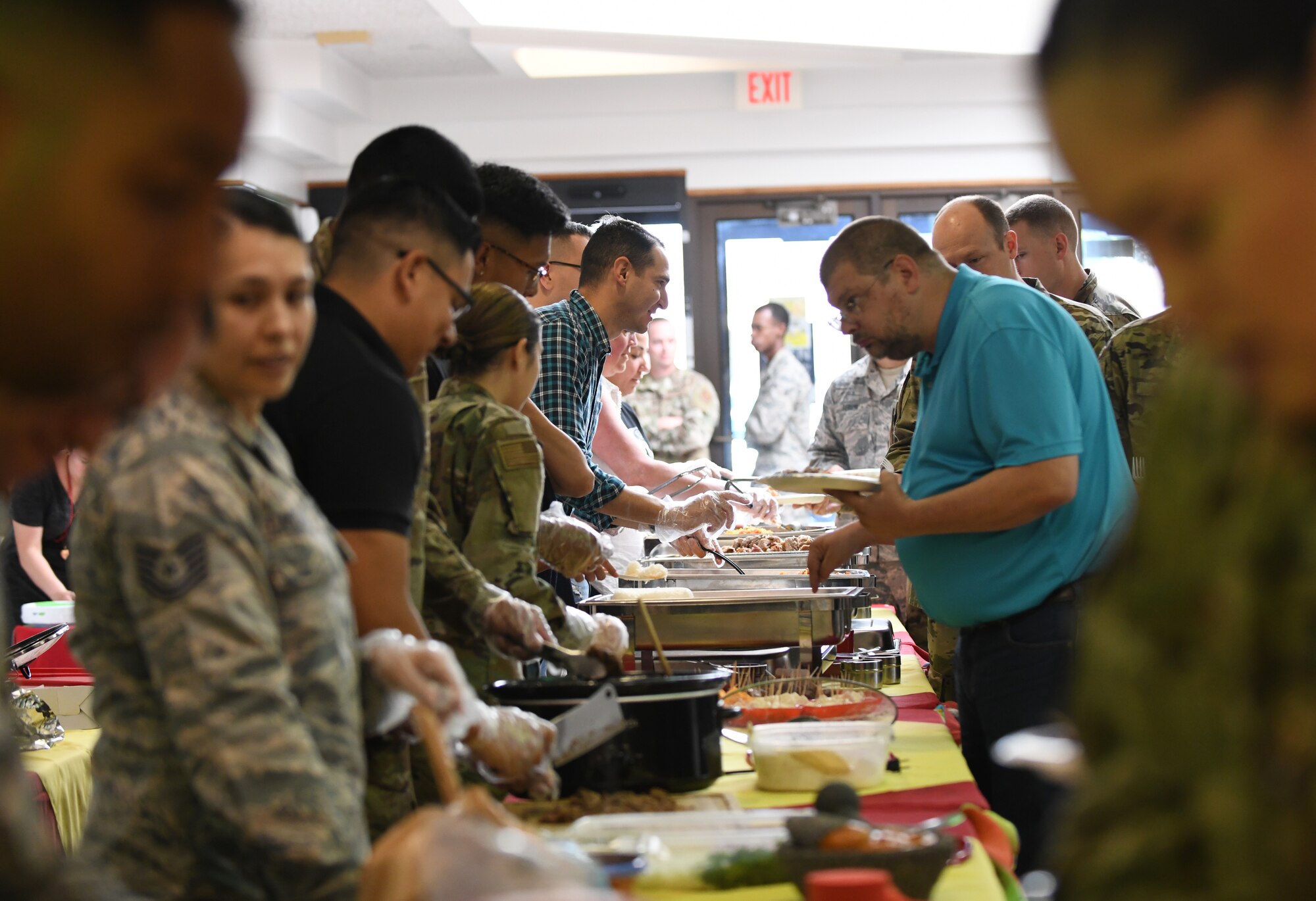 Volunteers from the Ellsworth Latin American Community (ELAC) serve authentic Latin American dishes to Airmen during a food tasting event, at the Base Exchange food court, on Ellsworth Air Force Base, S.D., Sept. 16, 2019. The ‘Taste of Latin America’ food tasting event marked the beginning of National Hispanic Heritage Month. Hispanic Heritage Month is observed in recognition of the diverse cultures and contributions of Latin American people. (U.S. Air Force photo by Airman 1st Class Christina Bennett)