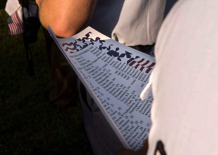 A U.S. Air Force Airman from the 30th Intelligence Squadron holds a list of names to be read during the 18th annual “Reading of the Names” at Gosnold's Hope Park, Sept. 11, 2019. At the event each volunteer picked up a list of names of the fallen and read them aloud around the memorial trees in the park. (U.S. Air Force Photo by Tech Sgt. Carlin Leslie)