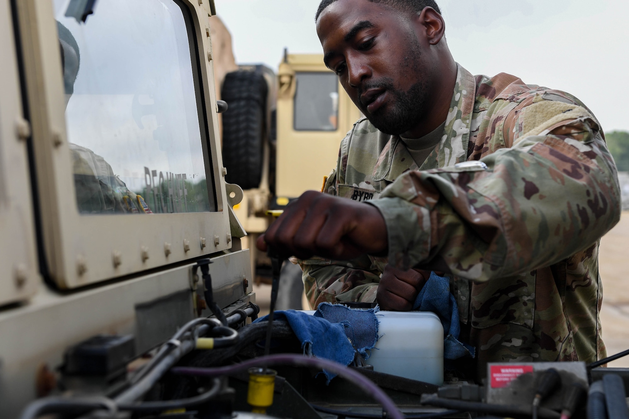 U.S. Army Spc. Ka’Shawn Byrd, a transportation management coordinator assigned to the 597th Transportation Brigade, 832nd Trans. Battalion, 688th Rapid Port Opening Element, performs an oil check on a Humvee at Joint Base Langley-Eustis, Virginia, Sept. 16, 2019. The 688th RPOE maintains Humvees, different variations of forklifts, medium tactical vehicle and a load handling system to accomplish their mission. (U.S. Air Force photo by Senior Airman Derek Seifert)