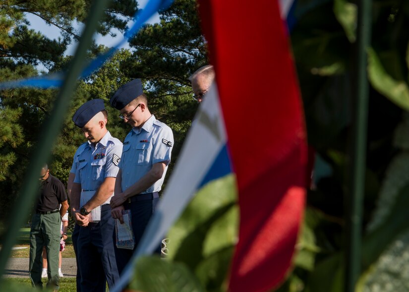 U.S. Air Force Airmen from the 30th Intelligence Squadron bow their heads during the prayer at the 18th annual “Reading of the Names” at Gosnold's Hope Park, Sept. 11, 2019. The Airmen volunteered their time to support the community and honor those who have paid the ultimate sacrifice. (U.S. Air Force Photo by Tech Sgt. Carlin Leslie)