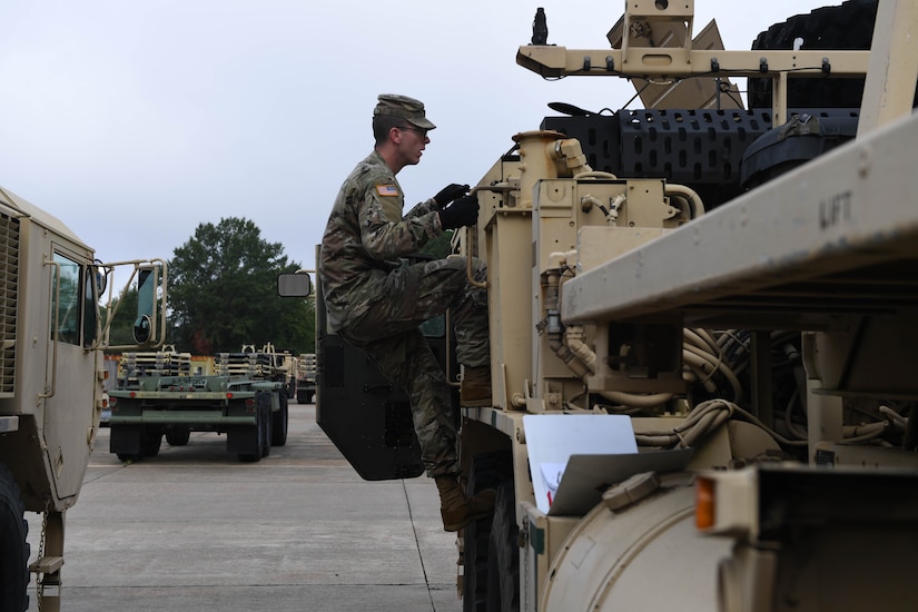 U.S. Army Spc. Daniel Mitchell, a heavy vehicle operator assigned to the 597th Transportation Brigade, 832nd Trans. Battalion, 688th Rapid Port Opening Element, performs preventative maintenance checks at Joint Base Langley-Eustis, Virginia, Sept. 16, 2019. During the weekly maintenance check Mitchell examined the engine and looked over the inside and outside of the vehicle to ensure there were no damages. (U.S. Air Force photo by Senior Airman Derek Seifert)