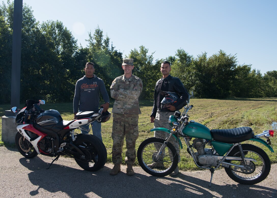 Staff Sergeants Trevor Griffin, Paul Kurtenbach, and Senior Airman Carlos Rivera, the 509th Munitions Squadron motorcycle safety representatives, stand for a group photo with their motorcycles on August 28, 2019, at Whiteman Air Force Base, Missouri. Safety representatives oversee the motorcycle safety programs within their units, identifying mentors, and promoting good and safe habits. (U.S. Air Force photo by Airman 1st Class Parker J. McCauley)