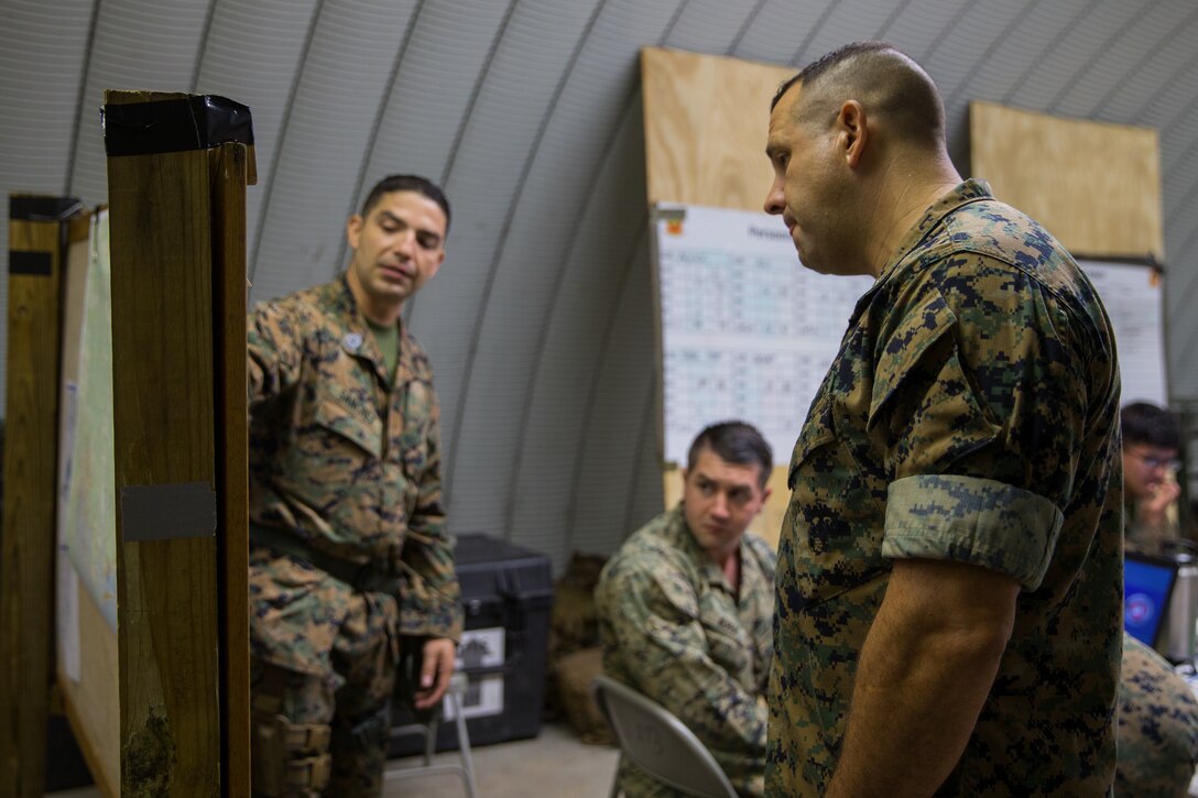Marines deliver a brief to Col. John P. Sullivan, the commanding officer of Marine Wing Support Group 27, prior to an aircraft recovery scenario at Marine Corps Auxiliary Landing Field Bogue, North Carolina, Aug. 16, 2019. ARFF Marines attached to Marine Wing Support Detachment 273 trained to improve readiness, efficiency, and recovery times.