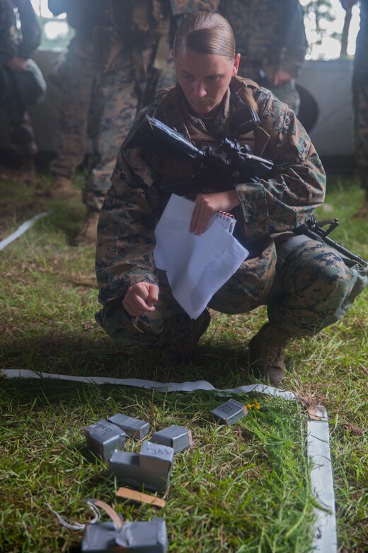 U.S. Marine Corps Sgt. Susan J. Clayton, convoy commander for an aircraft recovery scenario, observes a terrain model during a brief at Marine Corps Auxiliary Landing Field Bogue, North Carolina, Aug. 16, 2019. ARFF Marines attached to Marine Wing Support Detachment 273 trained to improve readiness, efficiency, and recovery times.