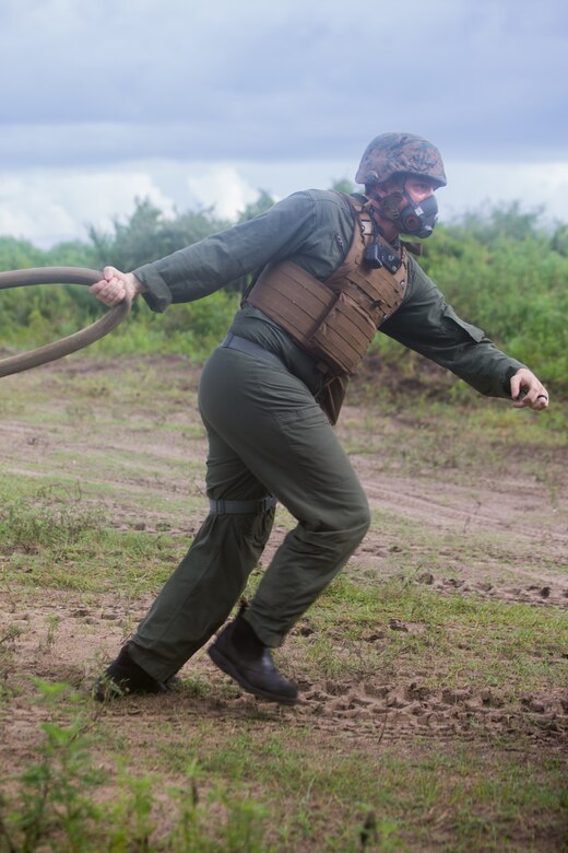 U.S. Marine Corps Cpl. Damian K. Laird, an aircraft rescue and firefighting specialist, transports a water hose during an aircraft recovery scenario at Marine Corps Auxiliary Landing Field Bogue, North Carolina, Aug. 15, 2019. ARFF Marines attached to Marine Wing Support Detachment 273 trained to improve readiness, efficiency, and recovery times.