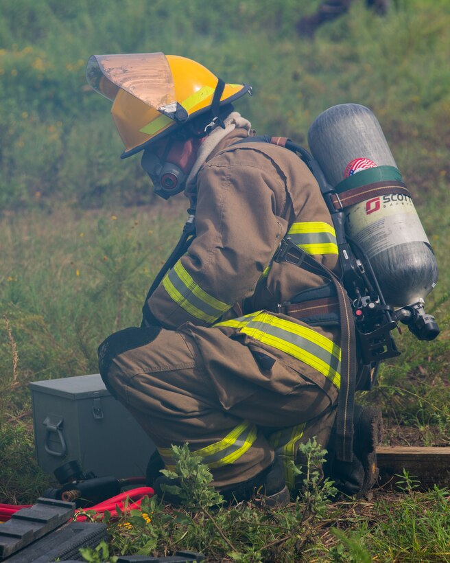 U.S. Marine Corps Cpl. Terrence D. Moran, an aircraft rescue and firefighting specialist, transports a fire hose during an aircraft recovery scenario at Marine Corps Auxiliary Landing Field Bogue, North Carolina, Aug. 15, 2019. ARFF Marines attached to Marine Wing Support Detachment 273 trained to improve readiness, efficiency, and recovery times.