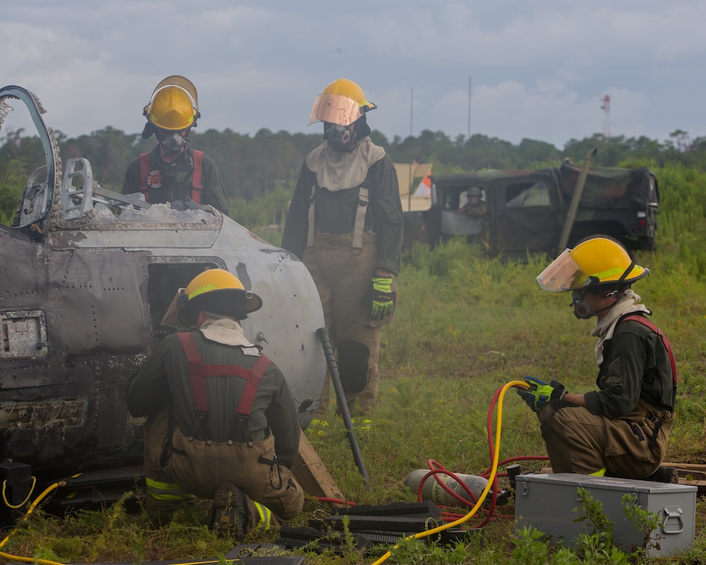Aircraft Recovery and Fire Fighting (ARFF) Marines measure areas of a crashed plane during an aircraft recovery scenario at Marine Corps Auxiliary Landing Field Bogue, North Carolina, Aug. 16, 2019. ARFF Marines attached to Marine Wing Support Detachment 273 trained to improve readiness, efficiency, and recovery times.
