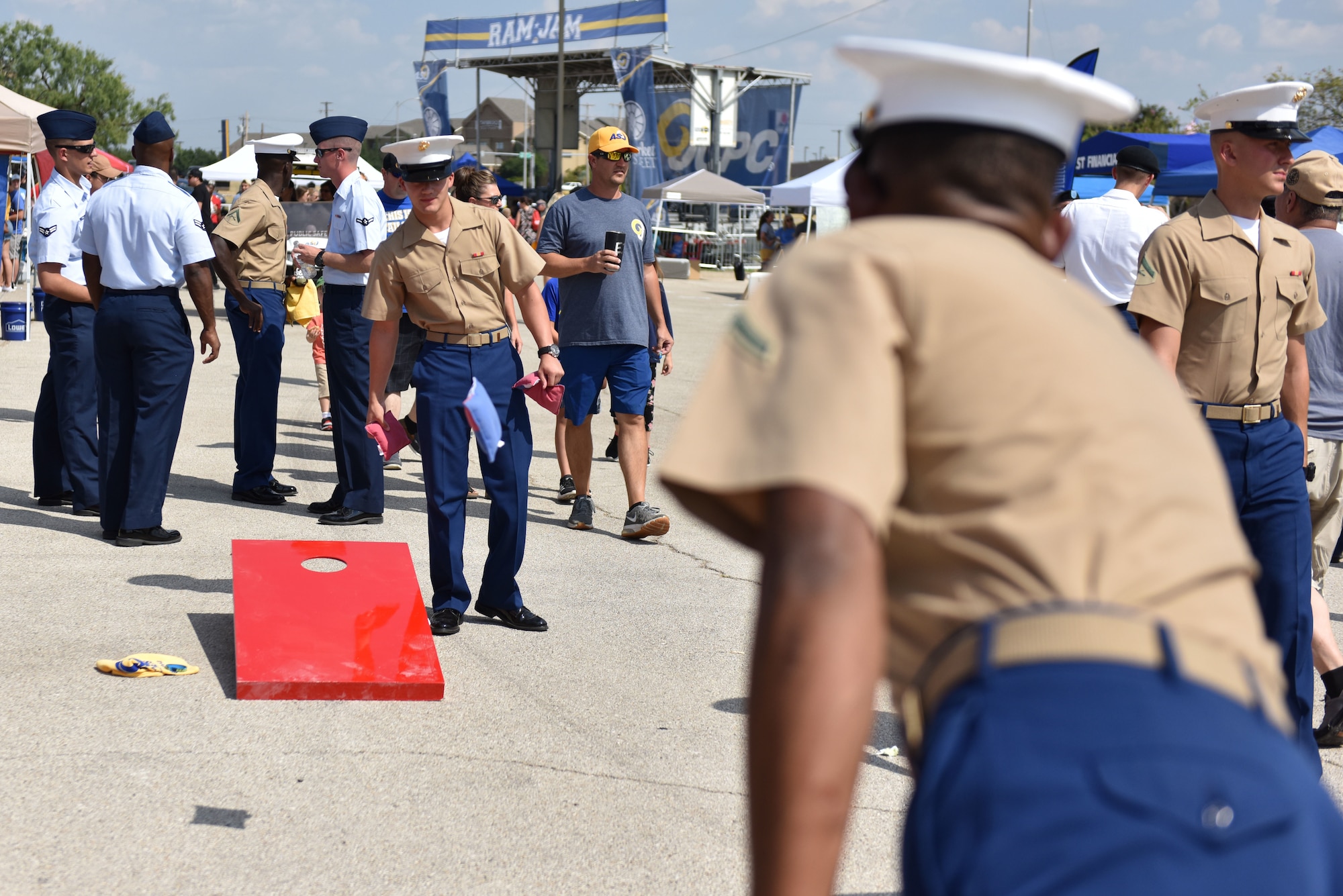Goodfellow members play a game of corn hole during the 2019 Ram Jam at the LeGrand Alumni Visitors Center before the Angelo State Military Appreciation night in San Angelo, Texas, Sept. 14, 2019. The Ram Jam is a tail gating event where individuals can enjoy games, food and live music. (U.S. Air Force photo by Senior Airman Seraiah Wolf/Released)