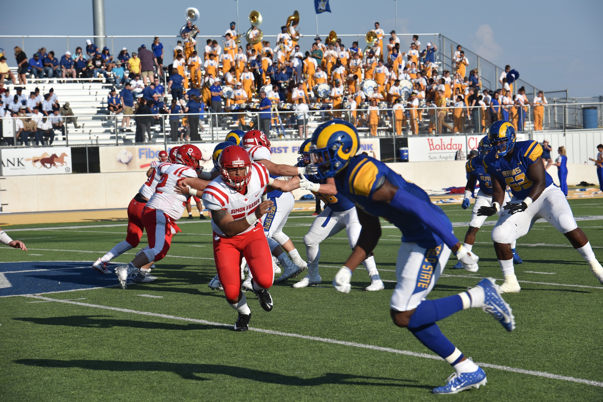 Angelo State University Rams and Simon Fraser University players compete during the ASU military appreciation night at 1st Community Credit Union Field, San Angelo, Texas, Sept. 14, 2019. ASU hosted SFU, a Canadian football team and won the game 68-7. (U.S. Air Force photo by Senior Airman Seraiah Wolf/Released)