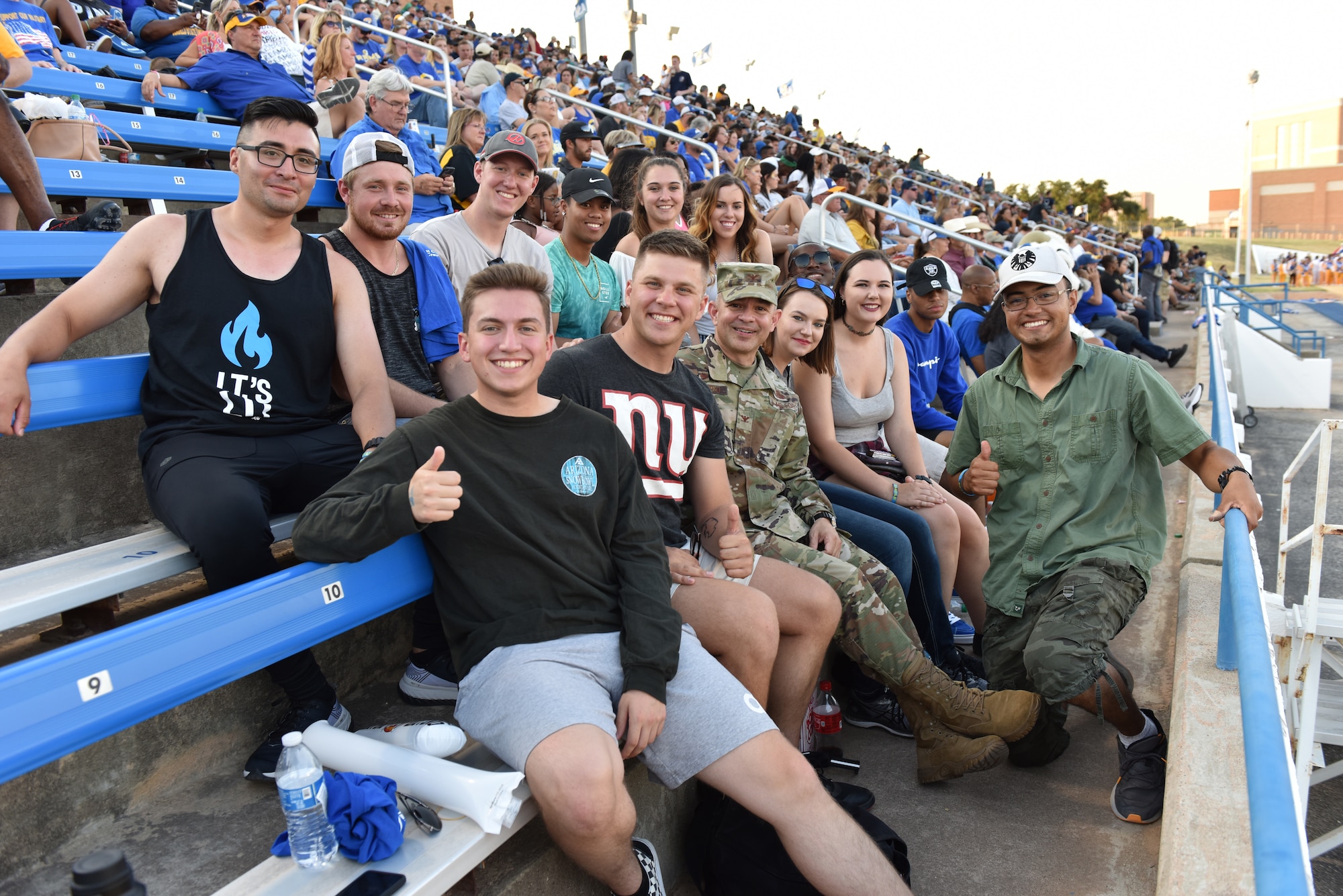 U.S. Air Force Col. Andres Nazario, 17th Training Wing commander, poses for a picture with 316th Training Squadron students attending the Angelo State University vs Simon Fraser University football game at 1st Community Credit Union Field, San Angelo, Texas, Sept. 14, 2019. ASU used the game to host military appreciation night, a way that they say thank you to all prior and active military members. (U.S. Air Force photo by Senior Airman Seraiah Wolf/Released)
