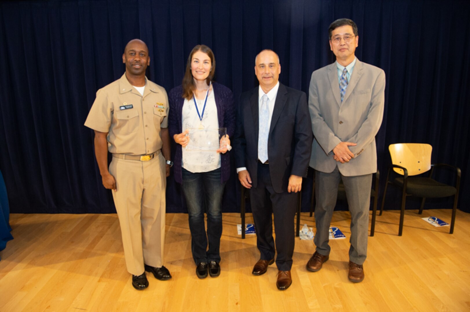 River Clemens, a scientist at the Acoustic Research Detachment, receives the Vice Adm. Samuel Gravely Award the Naval Surface Warfare Center, Carderock Division Honor Awards on Sept. 10, 2019, in West Bethesda, Md. With Clemens is Commanding Officer Capt. Cedric McNeal, Technical Director Larry Tarasek and Ship Signatures Department Head Dr. Paul Shang. (U.S. Navy photo by Nicholas Brezzell/Released)