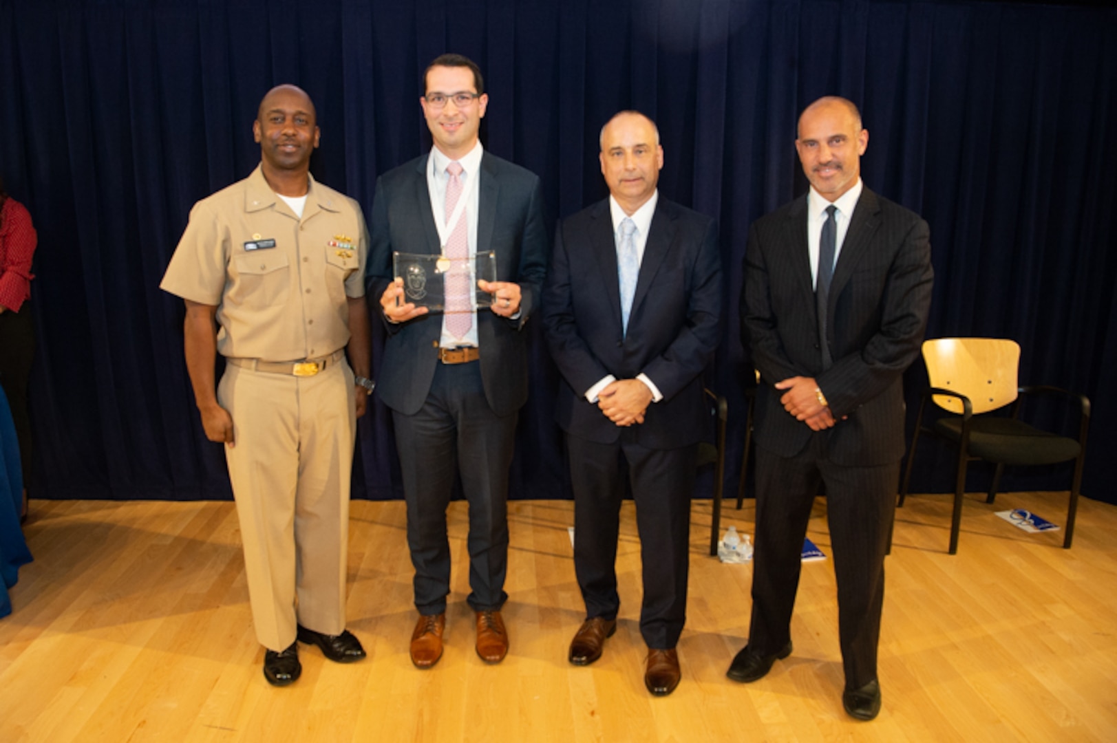 Michael Peduto, Contracts Division head, receives the Rear Adm. Grace Hopper Award the Naval Surface Warfare Center, Carderock Division Honor Awards on Sept. 10, 2019, in West Bethesda, Md. With Peduto is Commanding Officer Capt. Cedric McNeal, Technical Director Larry Tarasek and Contracting and Acquisition Department Head Tariq Al-Agba. (U.S. Navy photo by Nicholas Brezzell/Released)