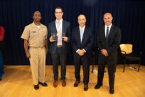 Michael Peduto, Contracts Division head, receives the Rear Adm. Grace Hopper Award the Naval Surface Warfare Center, Carderock Division Honor Awards on Sept. 10, 2019, in West Bethesda, Md. With Peduto is Commanding Officer Capt. Cedric McNeal, Technical Director Larry Tarasek and Contracting and Acquisition Department Head Tariq Al-Agba. (U.S. Navy photo by Nicholas Brezzell/Released)