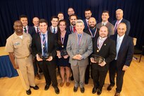 The next-generation, guided-missile frigate FFG(X) Design Team receives the Vice Adm. Emory Land Award the Naval Surface Warfare Center, Carderock Division Honor Awards on Sept. 10, 2019, in West Bethesda, Md. The team consists of Dr. Jason Strickland (team lead), Wesley Boone, David Colburn, Thomas Devine, Joseph Dvorak, Christian Henes, Jonathan Holbert, David Maxwell Jones, Joseph Lilly, Oliver Neal Raj, Jamie Shenk, Willard Sokol, Kariann Vander Pol, Trevor Wakeley and Wesley Wilson. Commanding Officer Capt. Cedric McNeal, Technical Director Larry Tarasek and Naval Architecture and Engineering Department Head Mike Brown presented the award. (U.S. Navy photo by Nicholas Brezzell/Released)