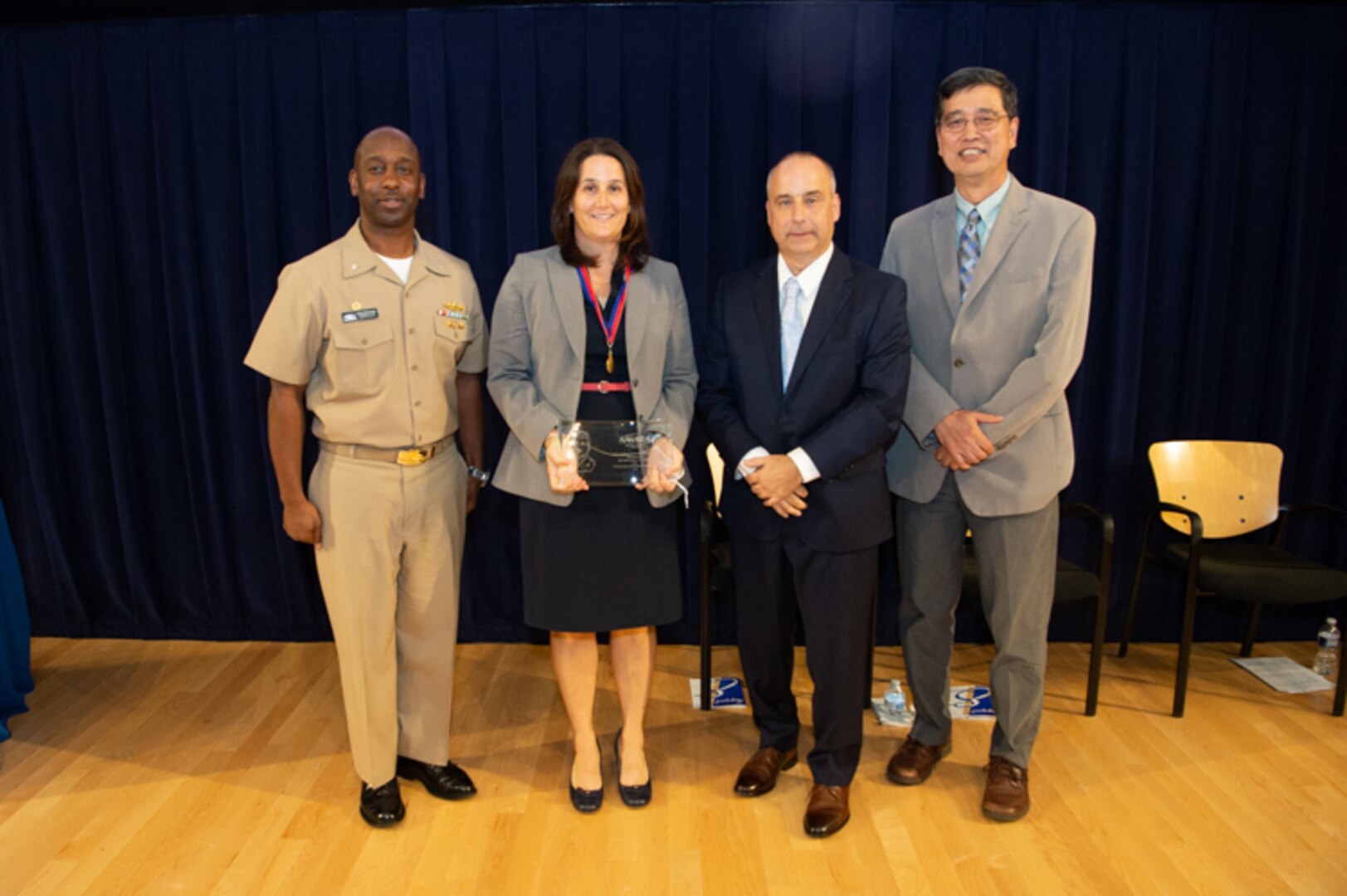 Dr. Anne Fullerton, head of the Emergent Technology Branch, receives the Rear Adm. David Taylor Award the Naval Surface Warfare Center, Carderock Division Honor Awards on Sept. 10, 2019, in West Bethesda, Md. With Fullerton is Commanding Officer Capt. Cedric McNeal, Technical Director Larry Tarasek and Ship Signatures Department Head Dr. Paul Shang. (U.S. Navy photo by Nicholas Brezzell/Released)
