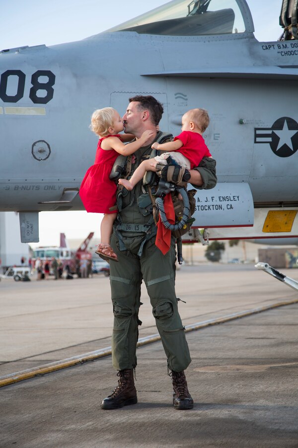 U.S. Marine Corps Capt. Brandon Dorsett, an F/A-18C Hornet pilot with Marine Fighter Attack Squadron (VMFA) 232 “Red Devils”, 3rd Marine Aircraft Wing, reunites with his family during a homecoming ceremony at Marine Corps Air Station Miramar, Calif., September 15, 2019. The Red Devils spent six months deployed as part of the unit deployment program. (U.S. Marine Corps photo by Sgt. Victoria Decker)