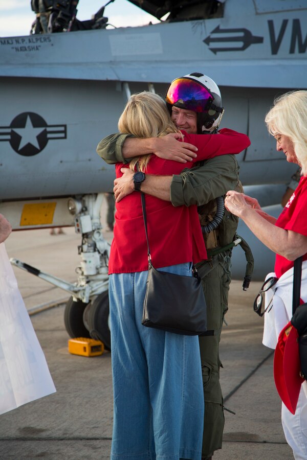 U.S. Marine Corps Maj. Nils Alpers, an F/A-18C Hornet pilot with Marine Fighter Attack Squadron (VMFA) 232 “Red Devils”, 3rd Marine Aircraft Wing, reunites with his family during a homecoming ceremony at Marine Corps Air Station Miramar, Calif., September 15, 2019. The Red Devils spent six months deployed as part of the unit deployment program. (U.S. Marine Corps photo by Sgt. Victoria Decker)