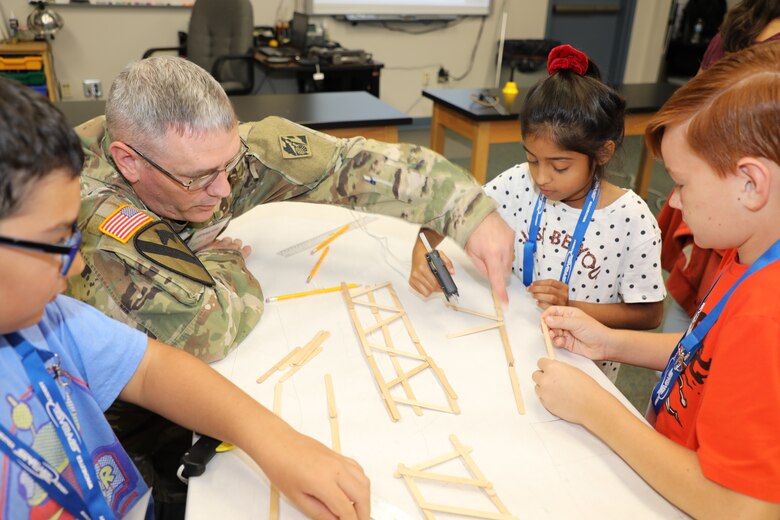 Col. Stephen Bales, a civil engineer and Deputy Commander for the U.S. Army Corps of Engineers Transatlantic Division in Winchester, Virginia, instructs students from Armel Elementary School in Frederick County, Virginia, on building a popsicle stick bridge using only glue guns, their own designs, and 100 popsicle sticks. The kids were participating in STARBASE, a Defense Department program designed to motivate fifth graders to explore educational opportunities in Science, Technology, Engineering, and Math (STEM) fields. The National Guard’s STARBASE Academy in Winchester is the only STARBASE program in Virginia, and hosts 56-58 courses a year for area schools.