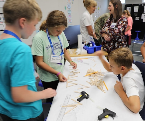 “Team Delta” students from Armel Elementary School in Frederick County, Virginia, begin construction of their popsicle stick bridge using only glue guns, their own designs, and 100 popsicle sticks. The kids were participating in STARBASE, a Defense Department program designed to motivate fifth graders to explore educational opportunities in Science, Technology, Engineering, and Math (STEM) fields. Team Delta’s design set a new record for Winchester’s program, holding 62 pounds before it collapsed.